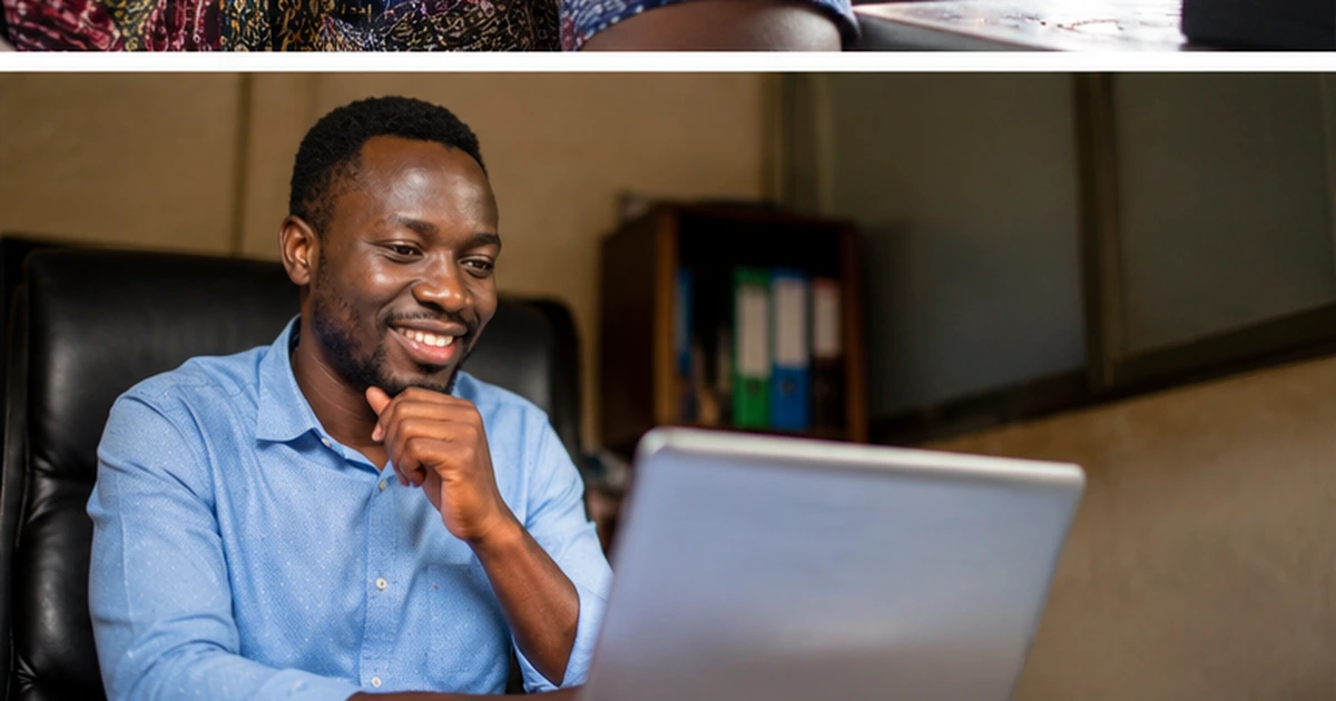 Ghanaian business owner smiling while reviewing results on laptop
